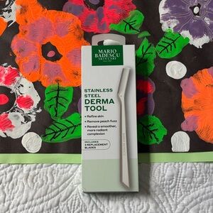 This is a Mario Badescu Stainless Steel Derma Tool with replacement blades